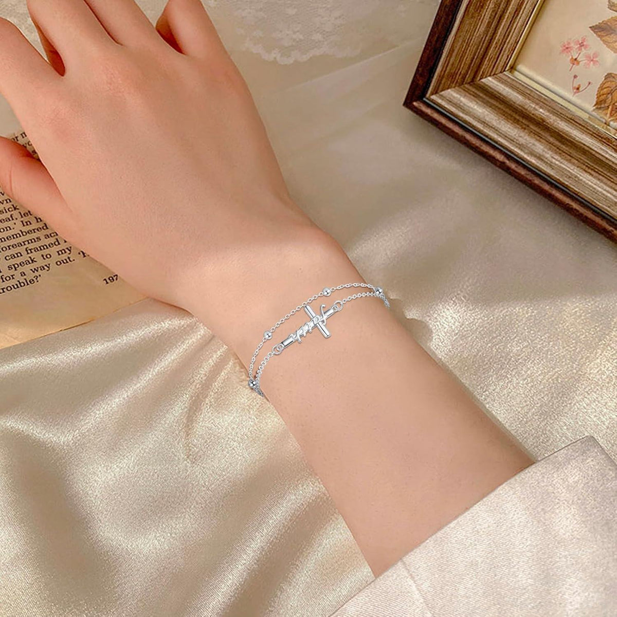 Silver bracelet on a wrist with a soft, neutral background